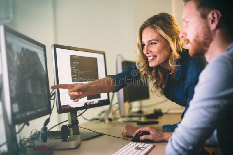 Programmer working in a software developing company office. Developing programmer stock images, royalty-free photos and pictures