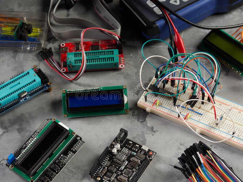 Programmers and Arduino with Peripherals and Expansion Boards Lie on a ...