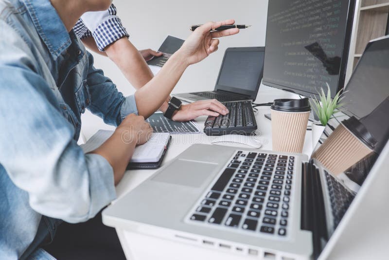 Programmers cooperating at Developing programming and website working in a software develop company office, writing codes and typing data code. Program coding working stock images, royalty-free photos and pictures