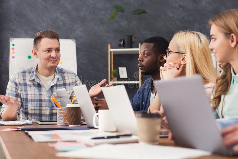 Team of young programmers working in software developing company, typing on laptops, testing new games or apps, copy space. Developing programmer stock images, royalty-free photos and pictures