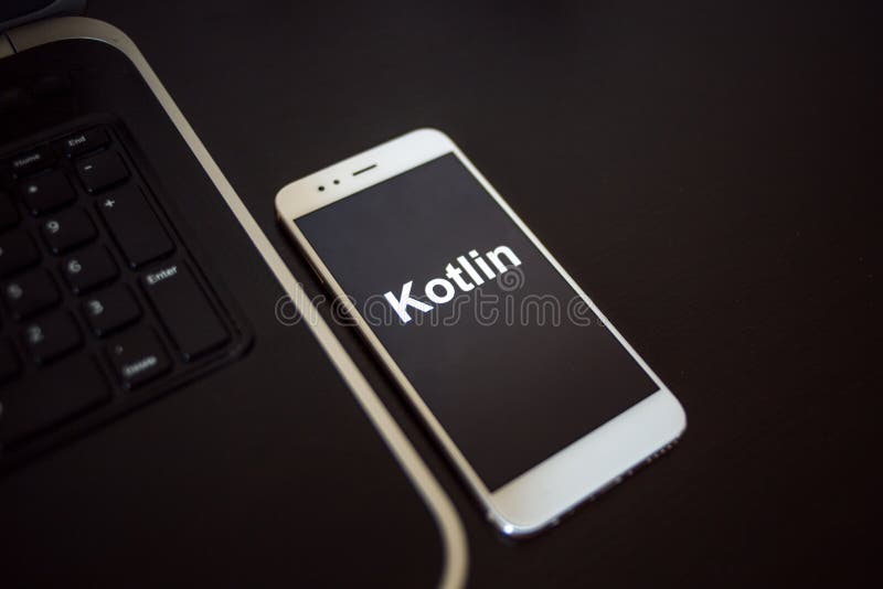 Programming language Kotlin for mobile development, concept. Smartphone near the laptop stock photo