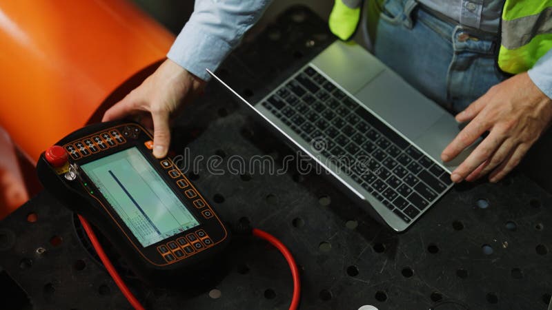 Programming robot controller, Programming robotic arms in factory industrial stock images