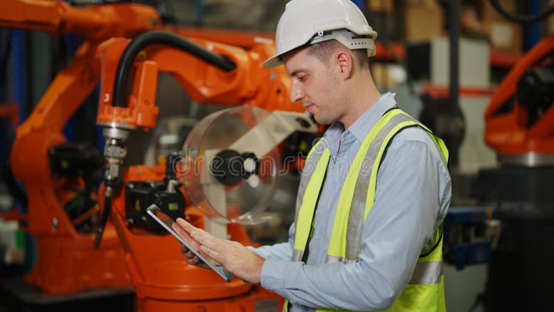 Programming robot controller, Programming robotic arms in factory industrial stock photos