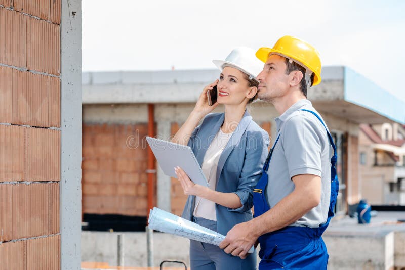 Project developer and construction worker on site using technology royalty free stock image Project developer and construction worker on site using technology royalty free stock image