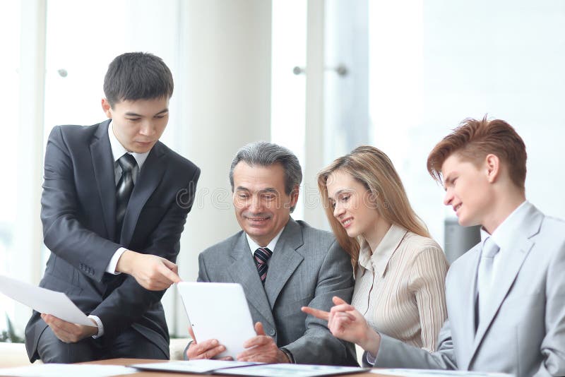 Project Manager and business team use a digital tablet to obtain operational information stock image Project Manager and business team use a digital tablet to obtain operational information stock image
