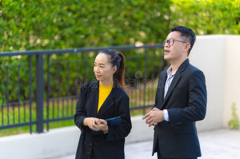 The project manager consults his assistant to check the progress o stock photo