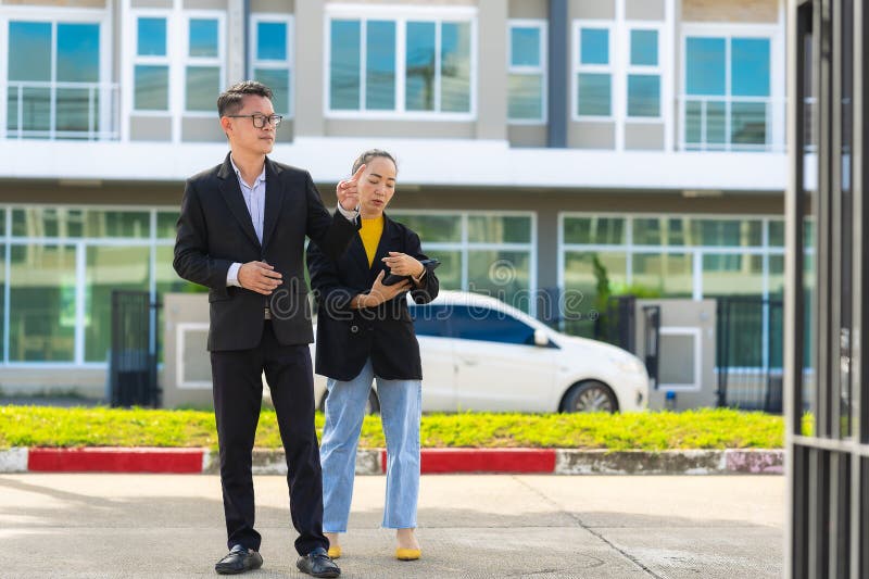 The project manager consults his assistant to check the progress o stock images