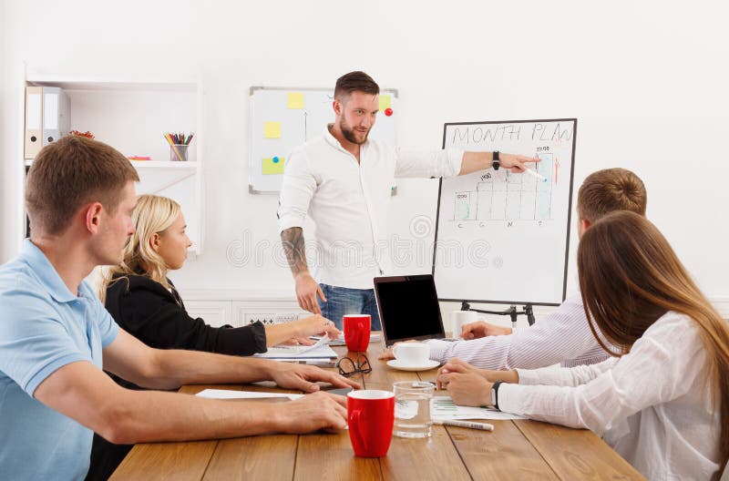 Project presentation. Young hipsters businessmen and women stock images Project presentation. Young hipsters businessmen and women stock images