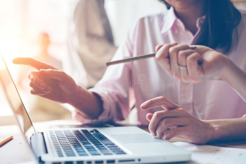 Project team discussing business plan. Laptop on the table, open space office stock images Project team discussing business plan. Laptop on the table, open space office stock images