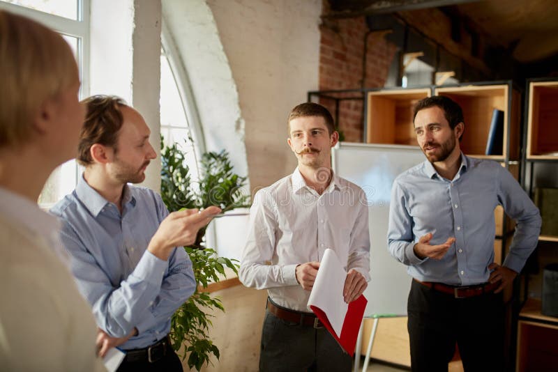 Young People Talking, Working, Discussing Problems and Ideas with Colleagues, Coworkers at