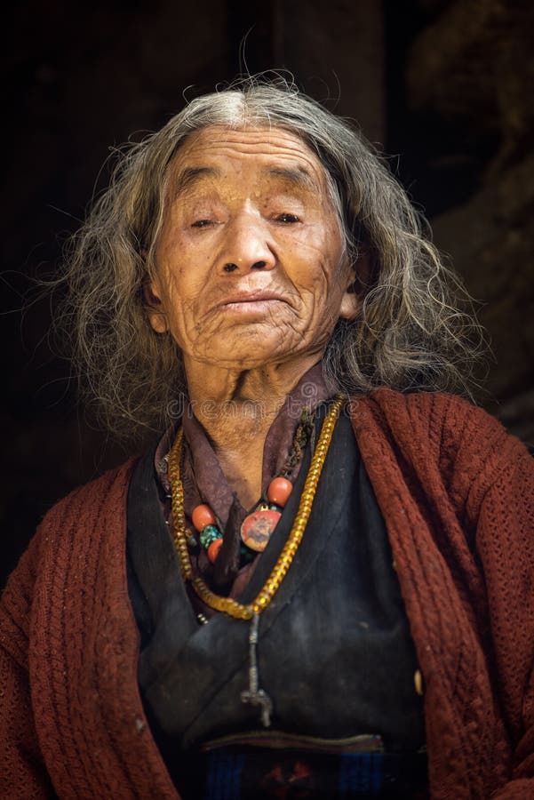 Portrait of a old nepalese woman in national clothes in her house