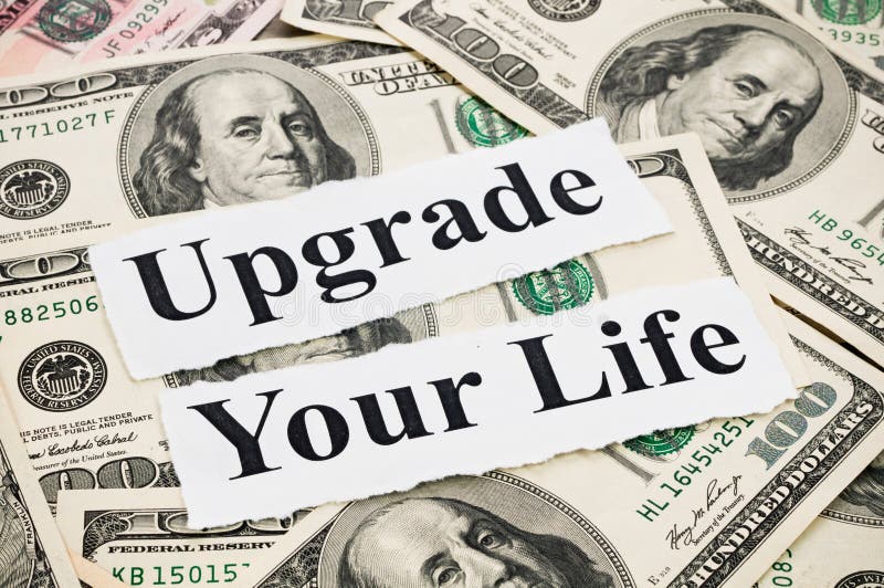 Upgrade your life by money, words on hundreds US notes background. Upgrade your life by money, words on hundreds US notes background