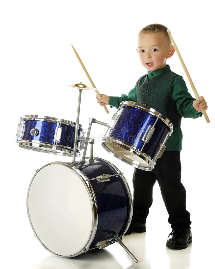 An adorable preschooler with drum sticks poised, waiting for a signal to begin his drum routine. On a white background. An adorable preschooler with drum sticks poised, waiting for a signal to begin his drum routine. On a white background.