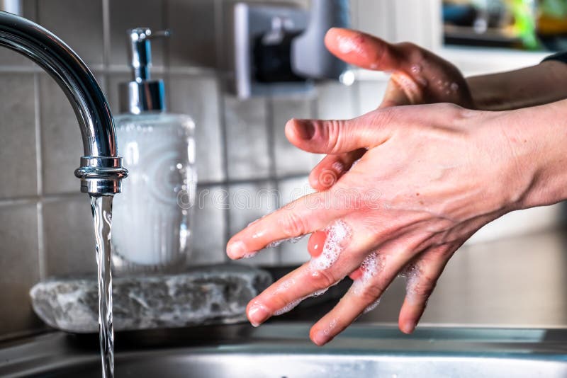 Proper Washing Of Hands Demonstrated At Steel Kitchen Sink Stock Photo