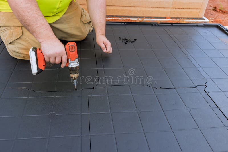 Properly screwing plastic base platform ensures stability of the plastic vinyl storage shed. stock images