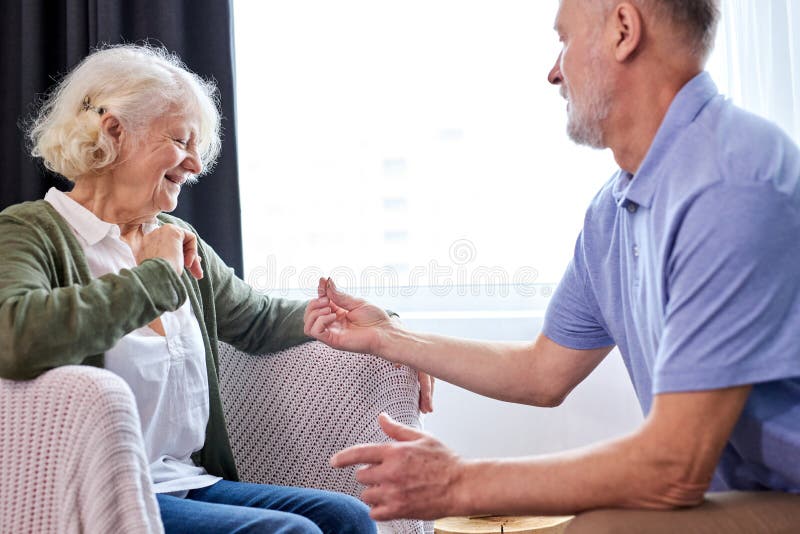 Proposal. senior man making a proposal and a happy woman smiling stock image