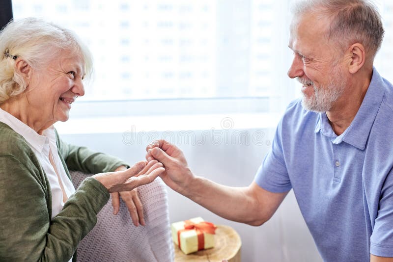 Proposal. senior man making a proposal and a happy woman smiling royalty free stock photography