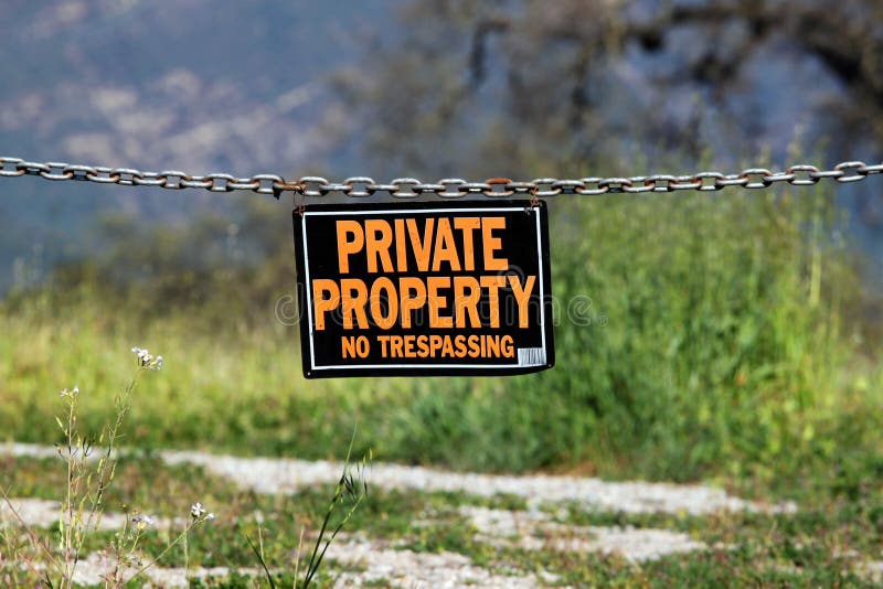 Black orange white private property hanging sign. Black orange white private property hanging sign