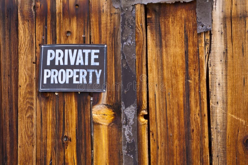 Private Property sign on old weathered wooden wall. Private Property sign on old weathered wooden wall