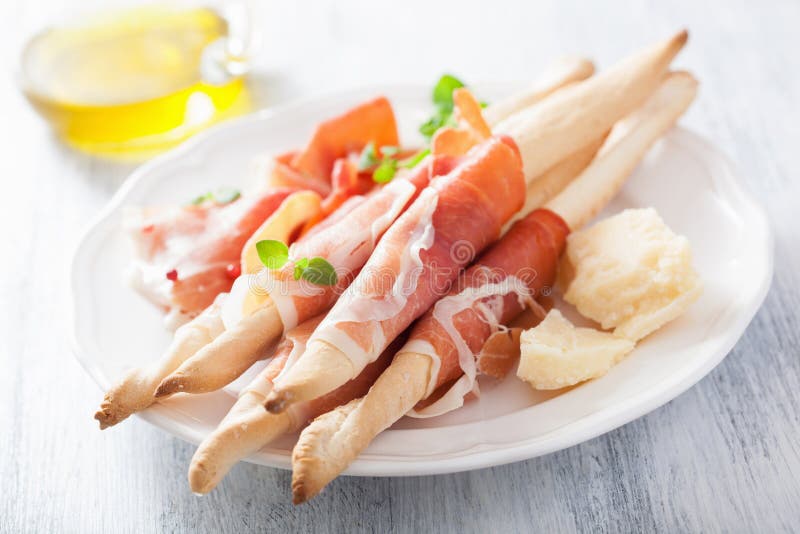Prosciutto ham and grissini bread sticks. italian antipasto stock photos Prosciutto ham and grissini bread sticks. italian antipasto stock photos