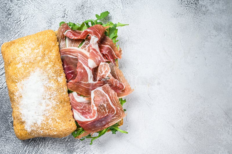 Prosciutto Parma Ham Sandwich on Ciabatta Bread with Arugula. White
