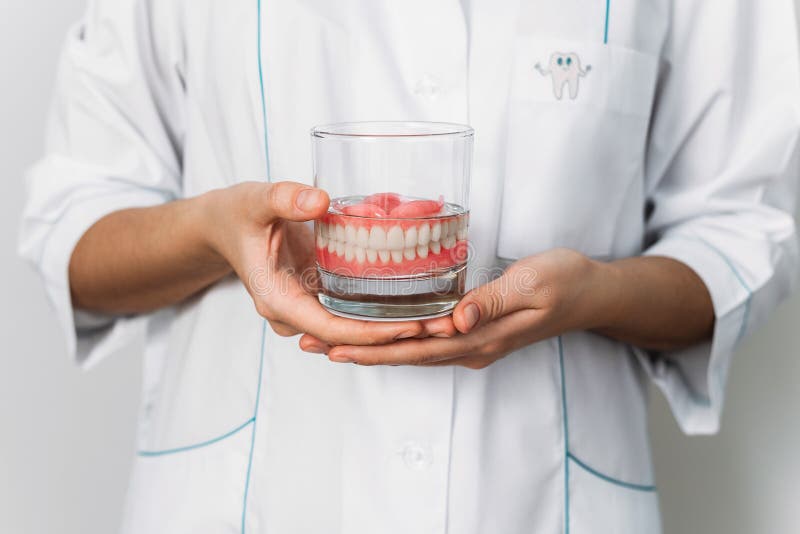 Prosthesis in a Glass with a Solution. Dental Prosthesis Care. Full
