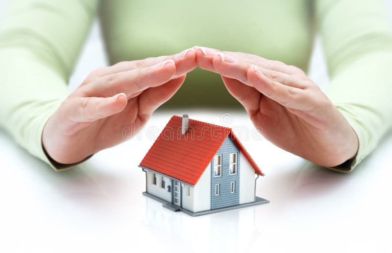 Protect and insurance real estate concept - house covered of hands