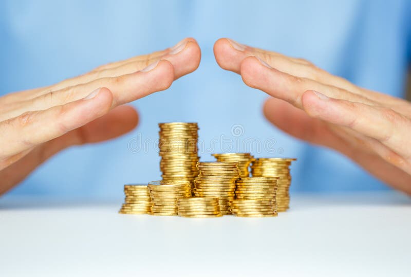 Protect new business start-up - with hands and coin. Finance, money.