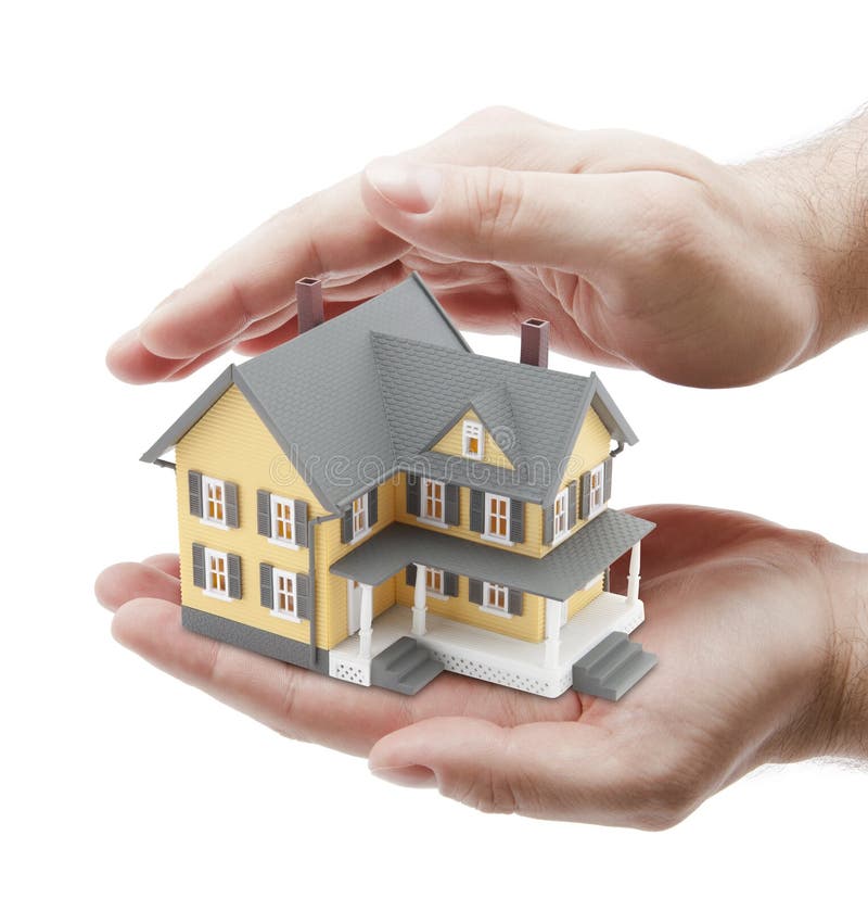 Hands covering small yellow house on white background. Hands covering small yellow house on white background