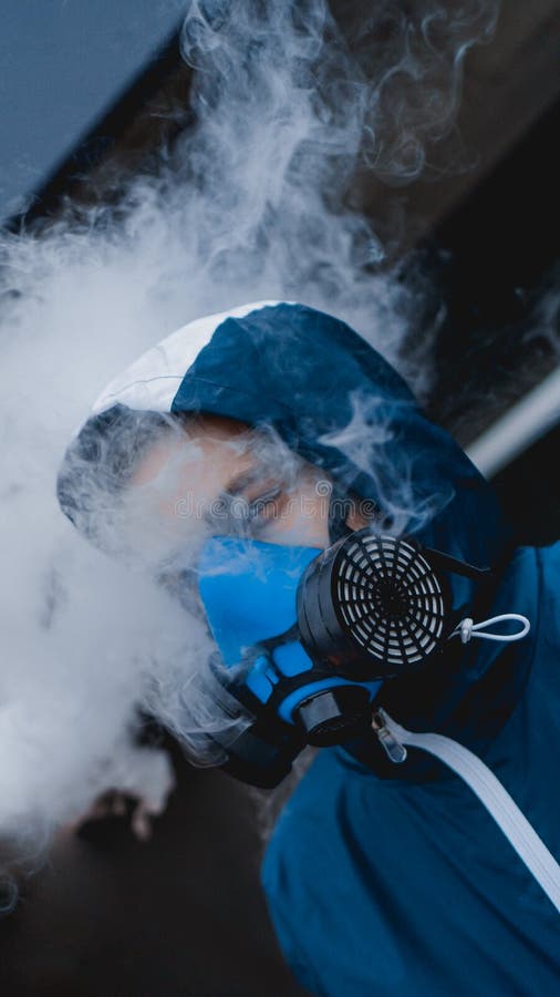Protection respirator half mask for toxic gas. The man prepare to wear protection air pollution in the chemical industry. Smoke stock photos Protection respirator half mask for toxic gas. The man prepare to wear protection air pollution in the chemical industry. Smoke stock photos