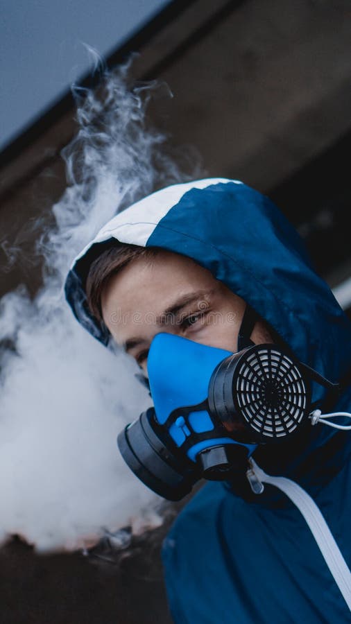 Protection respirator half mask for toxic gas. The man prepare to wear protection air pollution in the chemical industry. Smoke stock image Protection respirator half mask for toxic gas. The man prepare to wear protection air pollution in the chemical industry. Smoke stock image