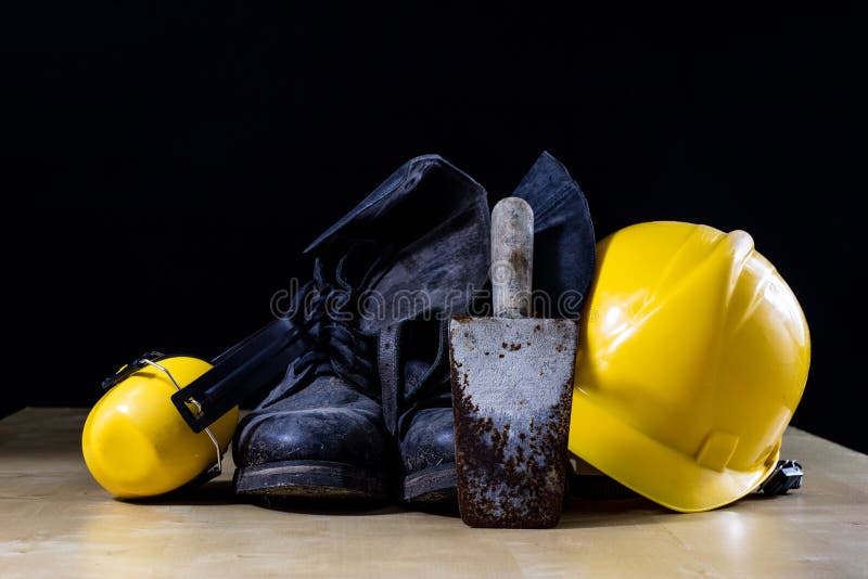 Protective clothing and tools lying on the workshop table. Buy a