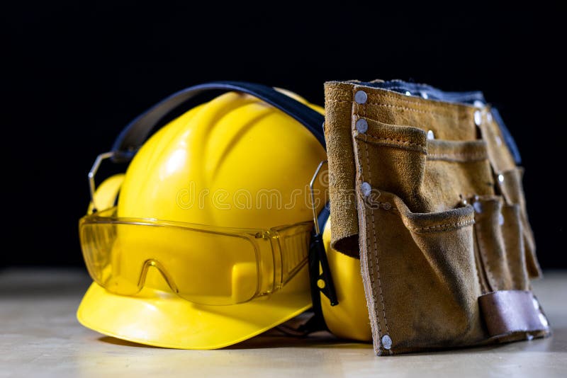 Protective clothing and tools lying on the workshop table. Buy a