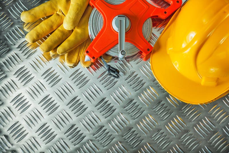 Protective gloves building helmet measuring tape on fluted metal stock images