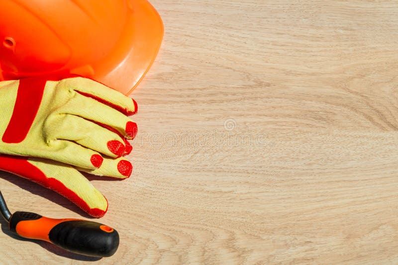 Protective hard hat, headphones, gloves, glasses and masks on wooden background, copy space stock image Protective hard hat, headphones, gloves, glasses and masks on wooden background, copy space stock image