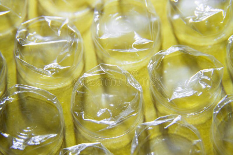 Protective Packaging Bubble Wrap on a Yellow Background Stock Photo