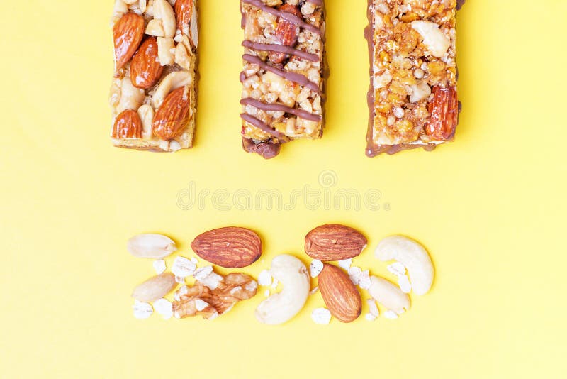 Protein Bars with Nuts on Yellow Background, Top View. Stock Image