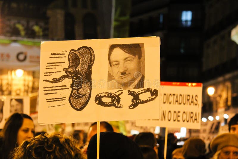 A protest in Madrid in February 2011, against the now ousted Egyptian president Hossni Mubarak. The photo shows a banner held by a protestor, depicting Hosni Mubarak as Hitler with a shoe thrown at him.