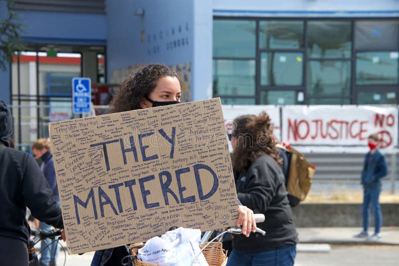 Alameda, CA - June 5, 2020: Protestors participating in  the George Floyd Black Lives Matter protest in Alameda, marching from Encinal High School to City Hall for a rally. Alameda, CA - June 5, 2020: Protestors participating in  the George Floyd Black Lives Matter protest in Alameda, marching from Encinal High School to City Hall for a rally