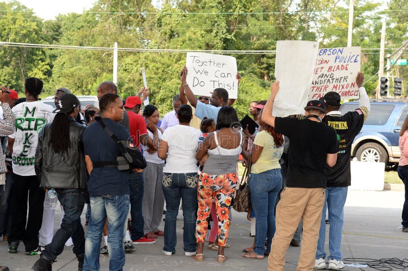 FERGUSON, MO/USA â€“ AUGUST 15, 2015: Protesters at the Site of Quick Trip react to Police Chief Thomas Jackson release of the name of the officer that shot Michael Brown. FERGUSON, MO/USA â€“ AUGUST 15, 2015: Protesters at the Site of Quick Trip react to Police Chief Thomas Jackson release of the name of the officer that shot Michael Brown.