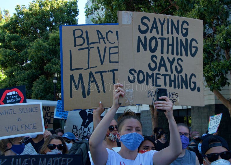 San Francisco, CA - June 3, 2020: Protestors at the George Floyd Black Lives Matter protest, some marching from Mission High School to Mission Police Dept and some to City Hall, holding signs. San Francisco, CA - June 3, 2020: Protestors at the George Floyd Black Lives Matter protest, some marching from Mission High School to Mission Police Dept and some to City Hall, holding signs