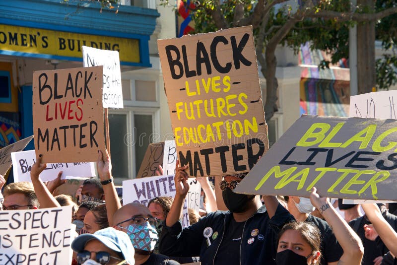 San Francisco, CA - June 3, 2020: Protestors at the George Floyd Black Lives Matter protest, some marching from Mission High School to Mission Police Dept and some to City Hall, holding signs. San Francisco, CA - June 3, 2020: Protestors at the George Floyd Black Lives Matter protest, some marching from Mission High School to Mission Police Dept and some to City Hall, holding signs