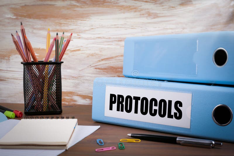 Protocols, Office Binder on Wooden Desk. On the table colored pe