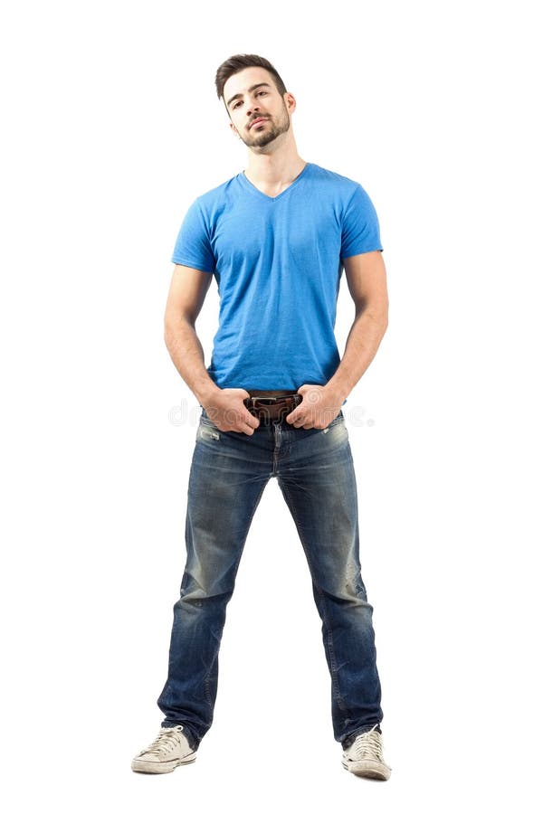 Proud confident man standing holding his belt
