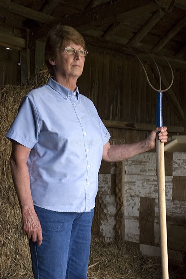 The Proud and Stoic Farmer Wife Standing in Barn