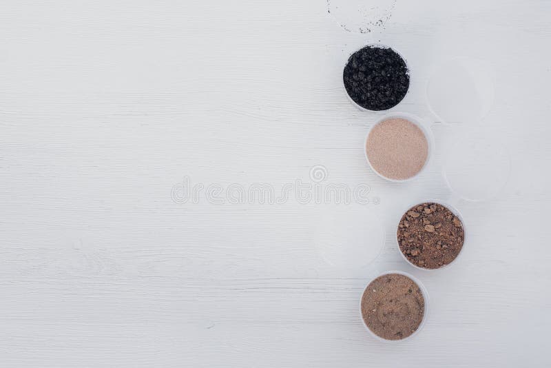 Samples of different types of soil in banks on the table. Soil science concept. Samples of different types of soil in banks on the table. Soil science concept