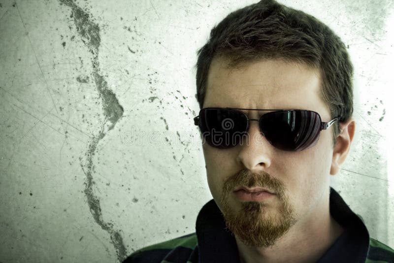 Dangerous looking guy, with beard and sunglasses. Dangerous looking guy, with beard and sunglasses