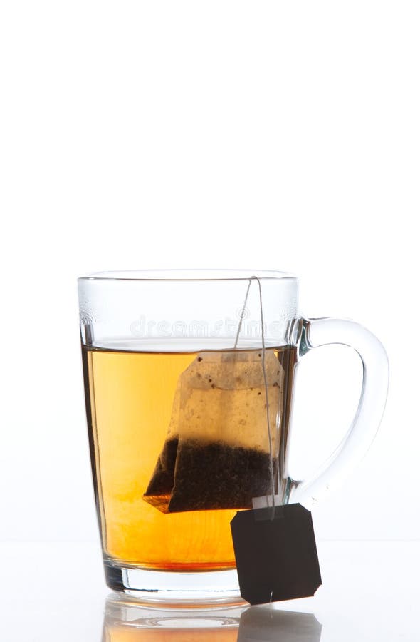 Tea bag in a hot transparent cup. Tea bag in a hot transparent cup