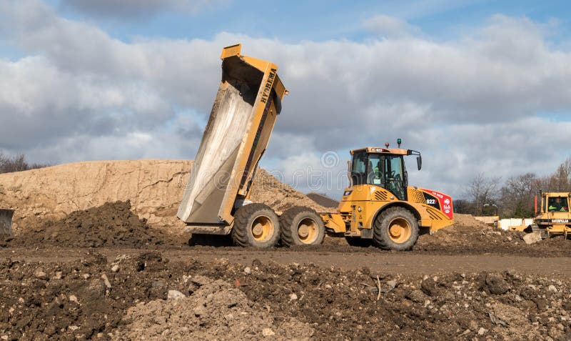 Peterlee / Great Britain : Industrial dumper truck moving tipping earth on a construction site. Peterlee / Great Britain : Industrial dumper truck moving tipping earth on a construction site