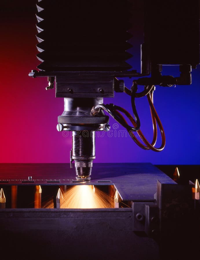 Industrial laser cutter with blue and red background, with sparks. Industrial laser cutter with blue and red background, with sparks